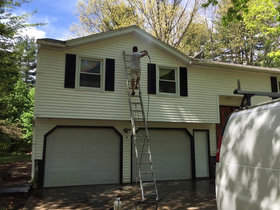 Power washing a Massachusetts home
